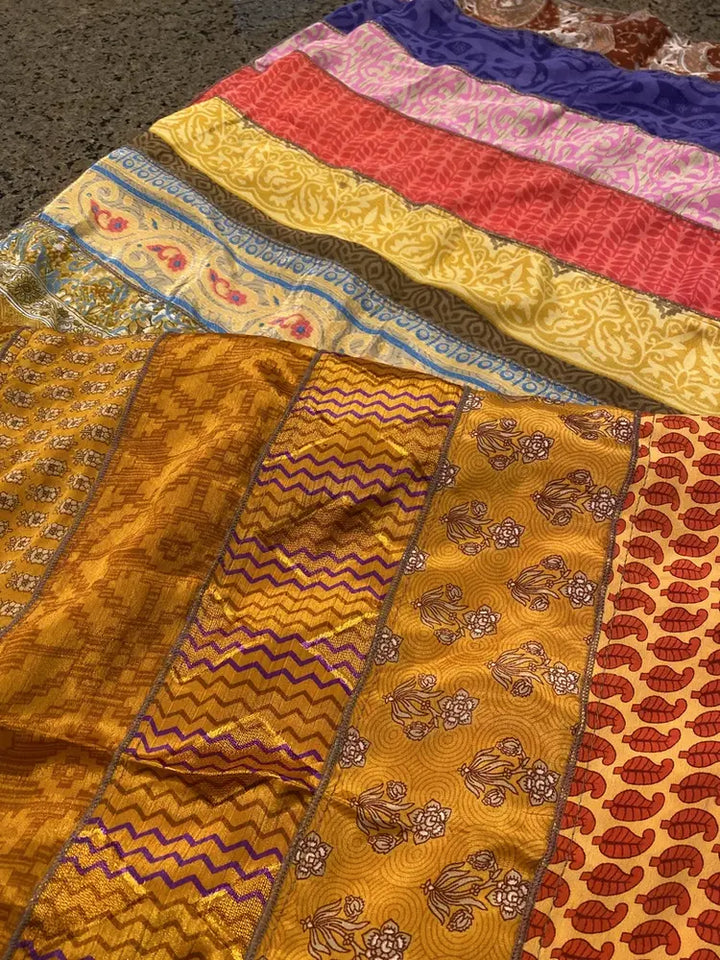 A colorful fabric patterns laid out on a surface, showcasing intricate designs and texture