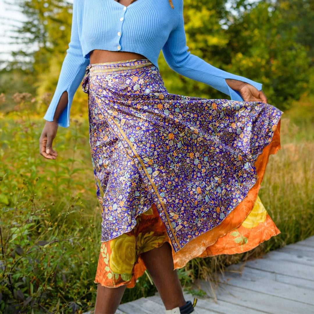 A close up of a woman wearing sari wrap skirt.