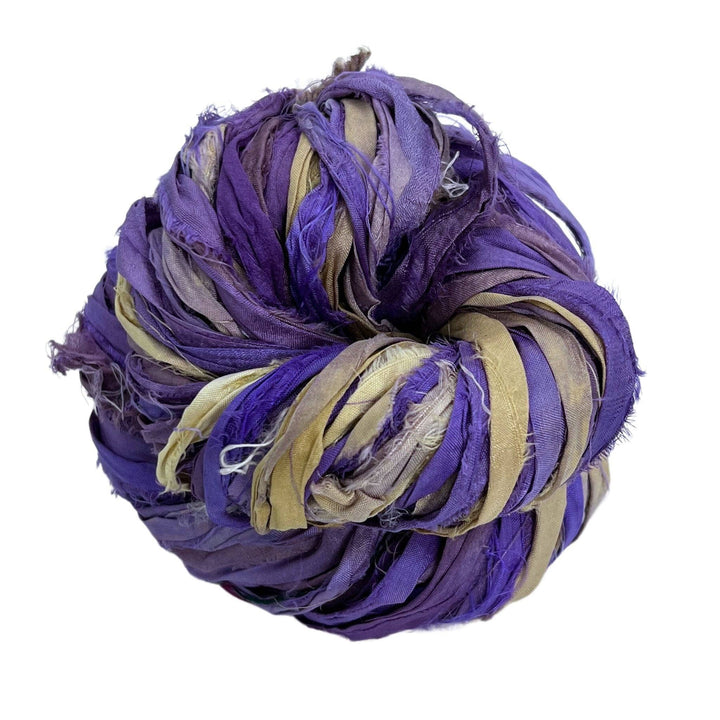 A used purple sari silk Yarn rolled.
