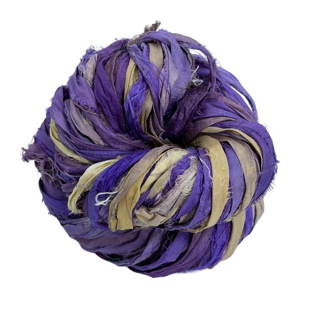 A used purple sari silk Yarn rolled.