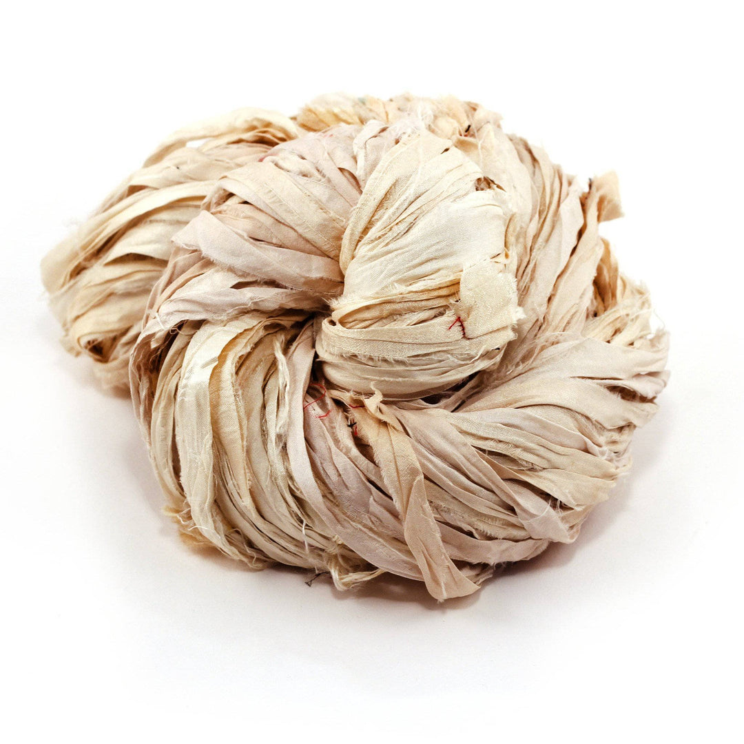 Bundle of twisted beige raffia ribbon on a white background.