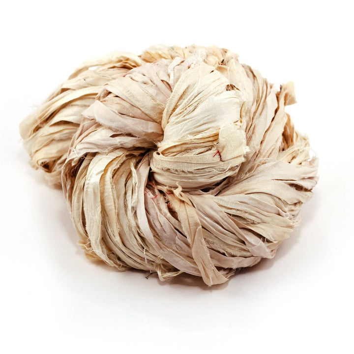 Bundle of twisted beige raffia ribbon on a white background.