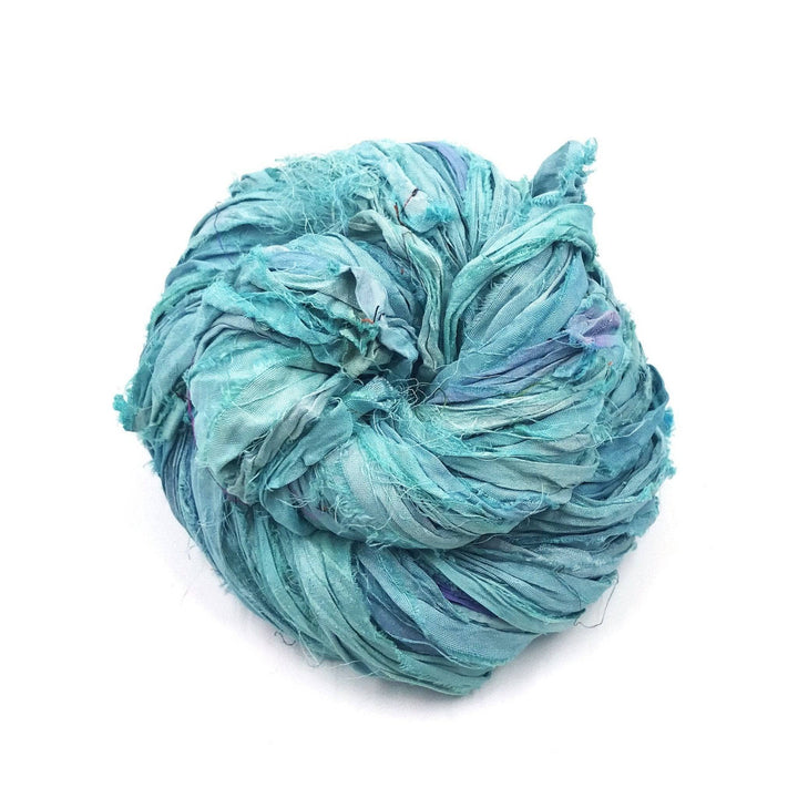 A used sky blue sari silk Yarn rolled.