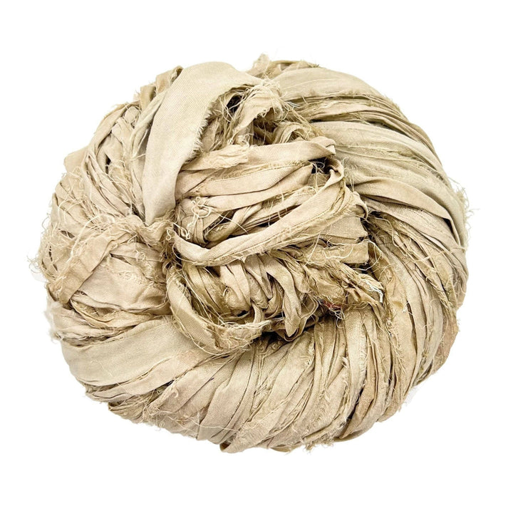A large ball of beige frayed fabric strips coiled together.