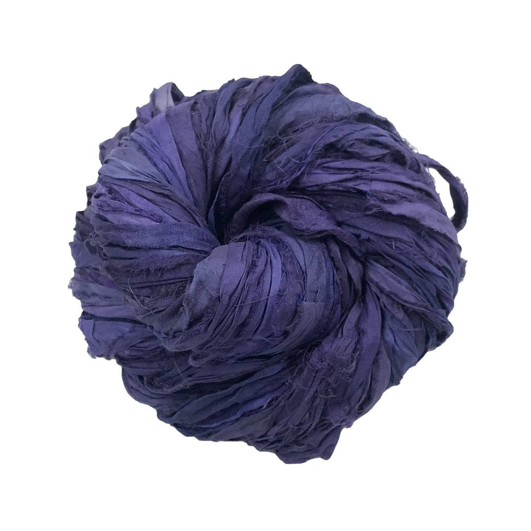 A tightly wound ball of dark purple silk ribbon yarn against a white background.