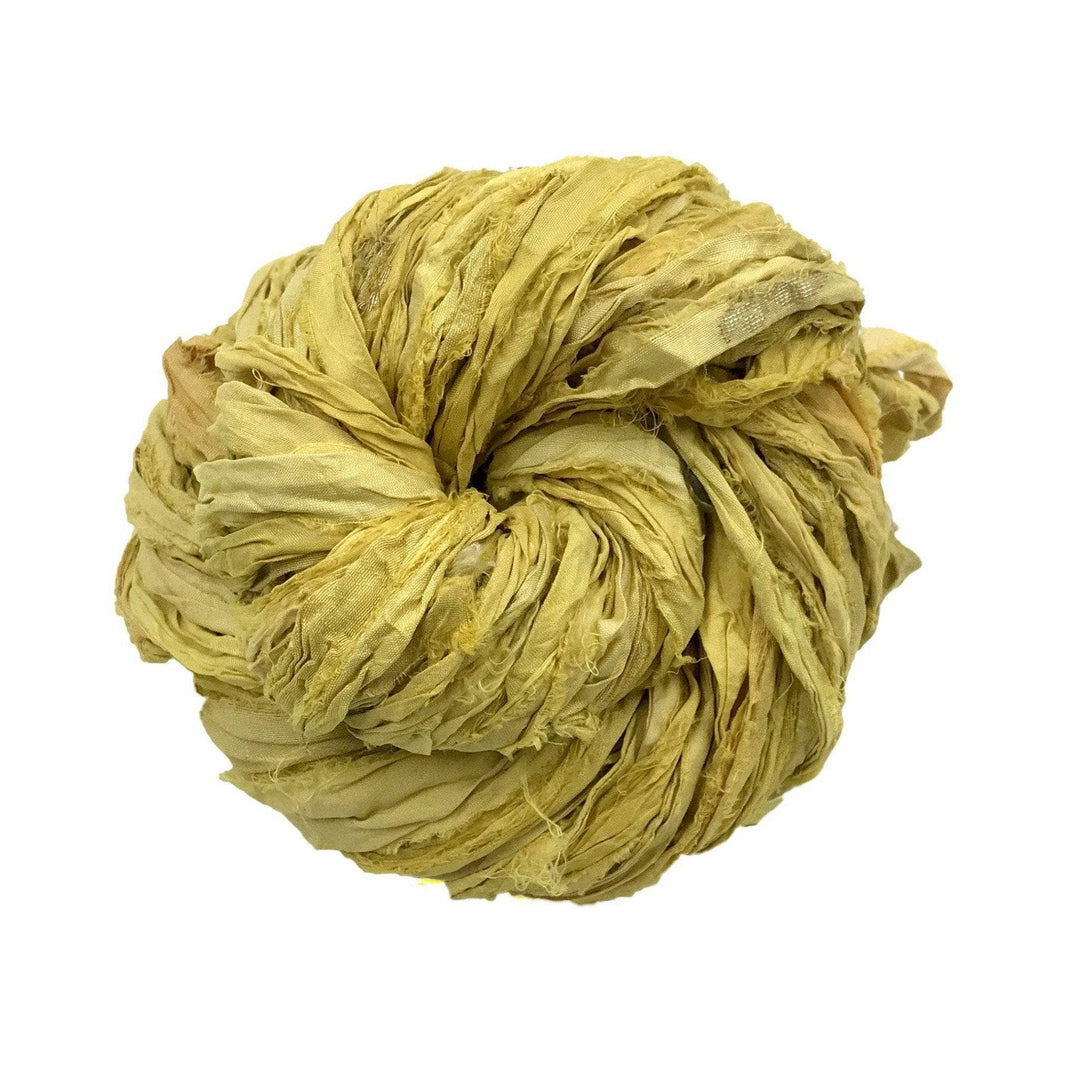 A twisted ball of yellowish fabric strips, coiled tightly into a round shape.