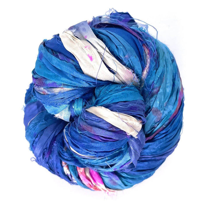 A ball of blue yarn with pink, purple, and white accents, tightly wound together.