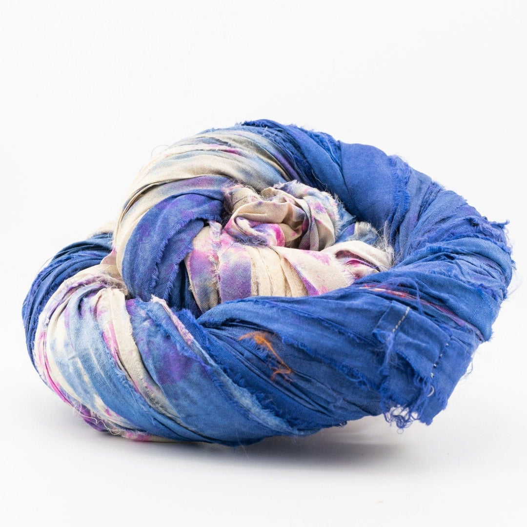 Close-up of a twisted bundle of colorful fabric in blue, pink, and beige shades.